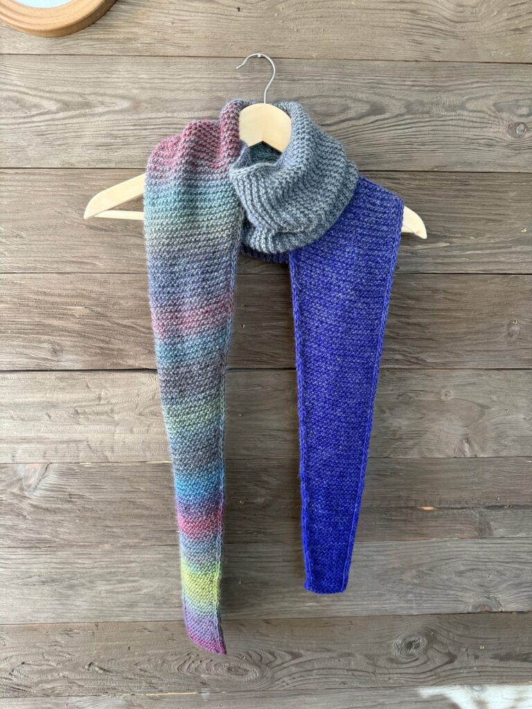 Knitted multicolored striped scarf.