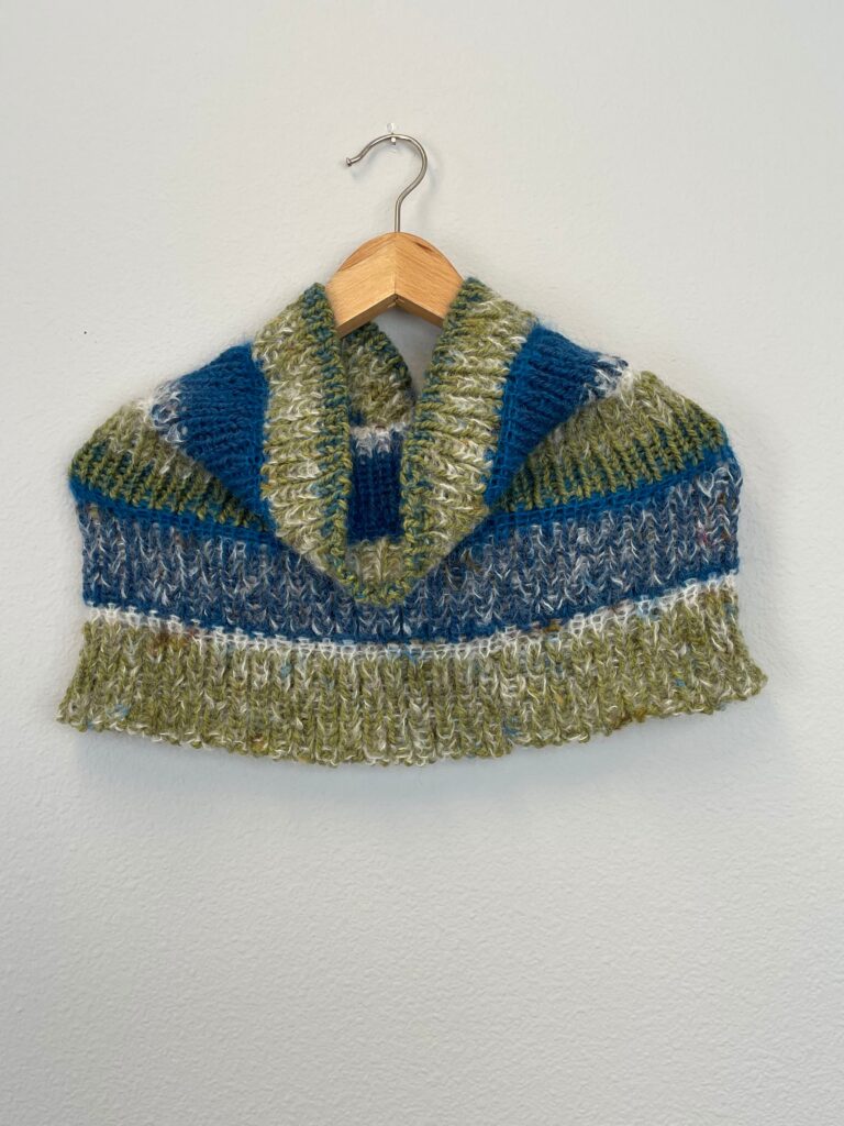 Knitted cowl shrug in blue and green.